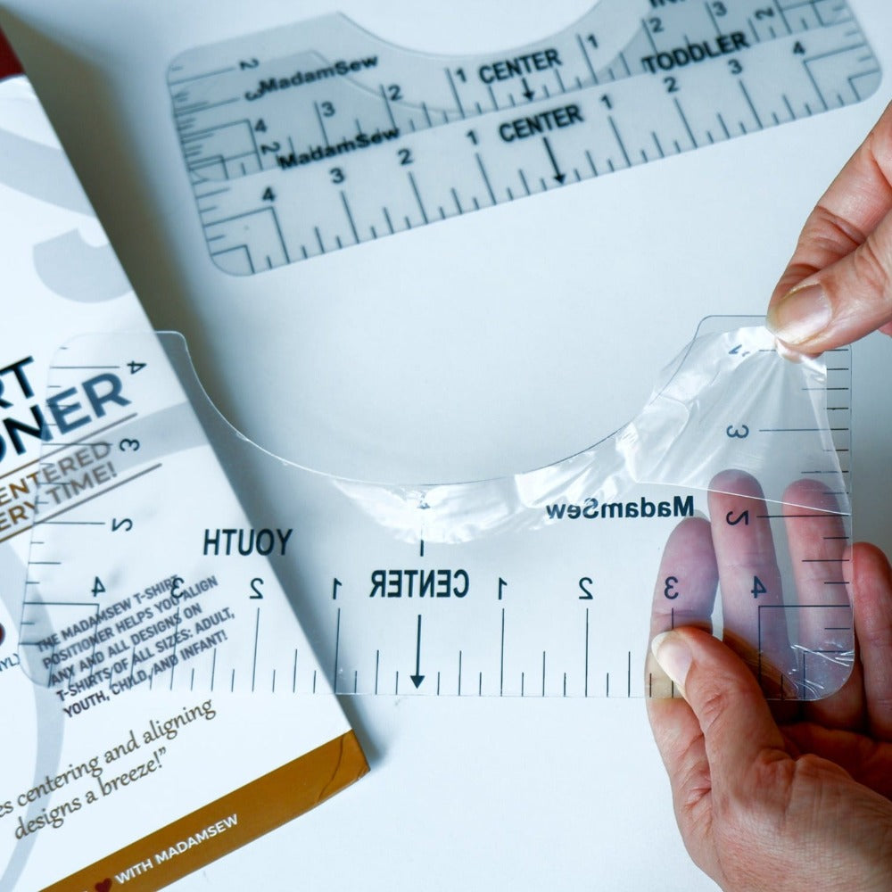 hands removing the protective film on the tshirt ruler